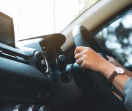 a woman holding steering wheel